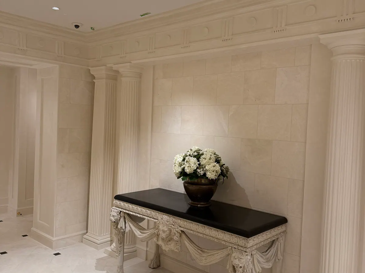 Finished commercial interior with aligned wall panels, trim, and lighting