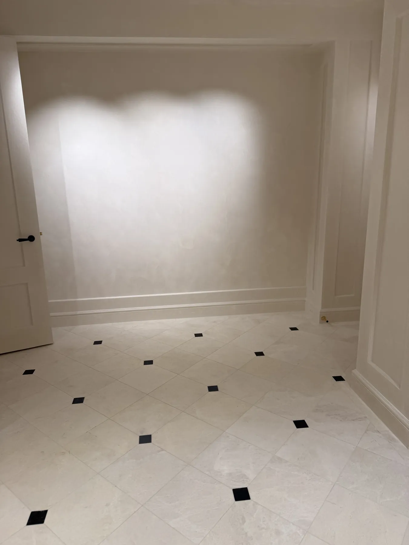 Finished room with wall moulding and recessed lighting