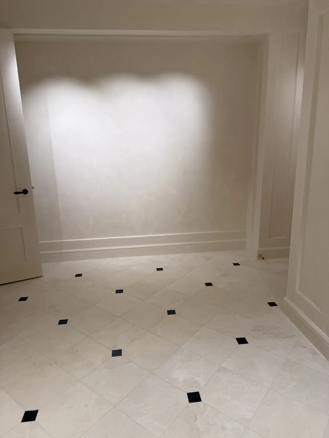 Finished wall surface with aligned trim and architectural moulding